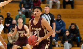 Norwich University men's basketball player gets ready to shoot a basket.