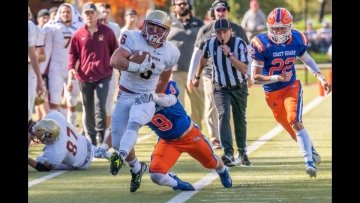 A NU football player breaks away from the Coast Guard defense during the annual “Little Army Navy” game racing down field to score a touchdown. The annual match-up has a “colorful” history of pranks and shenanigans.